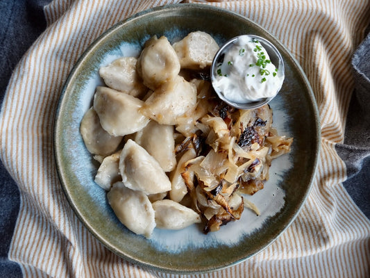 Potato & Cheddar Cheese Perogies with ‘Berkshire’ Bacon, Charred Onions & Sour Cream